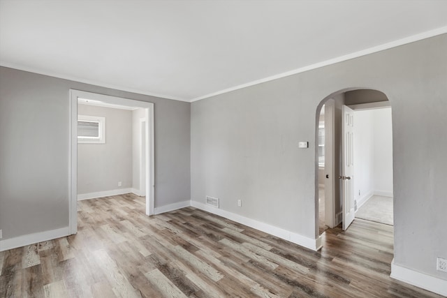 23737 Couzens Ave, Hazel Park, MI 48030 - empty room featuring arched walkways, wood finished floors, crown molding, and baseboards