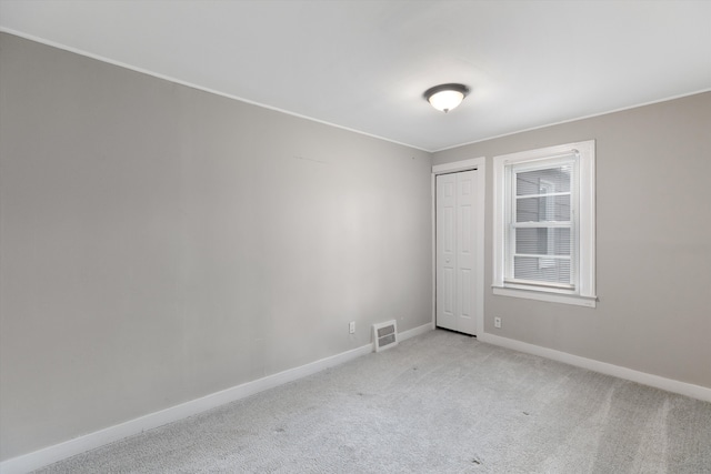23737 Couzens Ave, Hazel Park, MI 48030 - spare room with light colored carpet, baseboards, and visible vents