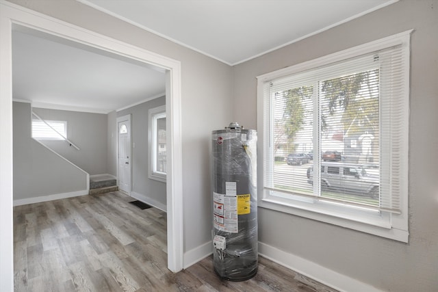 23737 Couzens Ave, Hazel Park, MI 48030 - entrance foyer with wood finished floors, water heater, ornamental molding, and a healthy amount of sunlight