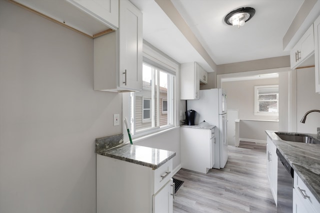 23737 Couzens Ave, Hazel Park, MI 48030 - kitchen with dishwasher, freestanding refrigerator, a sink, and dark stone counters
