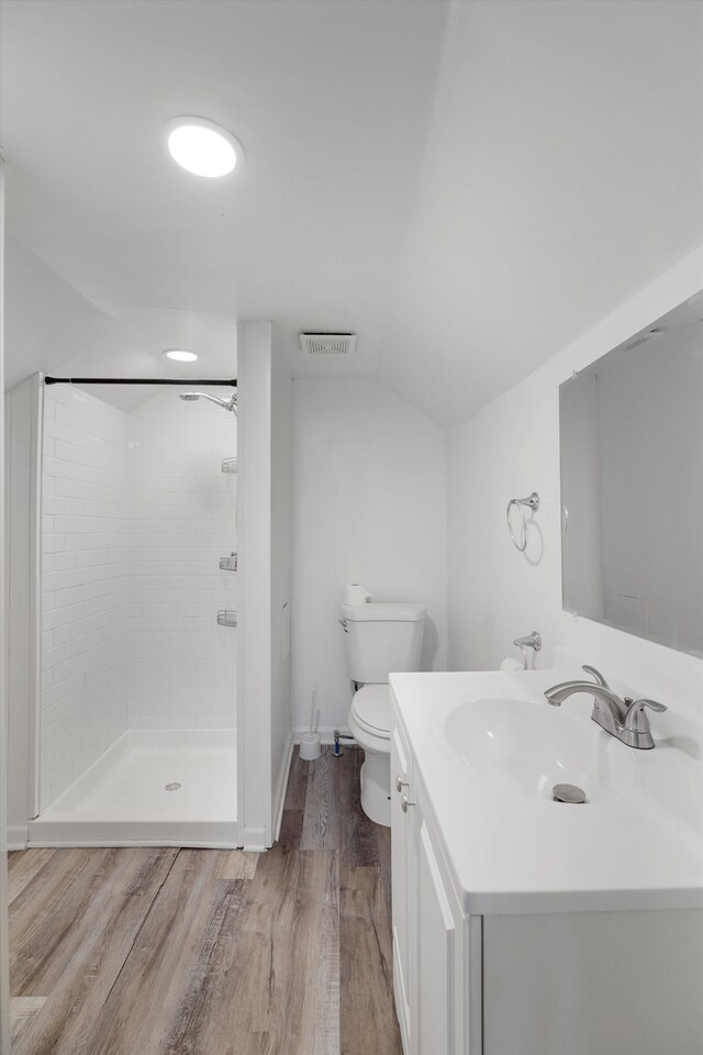 23737 Couzens Ave, Hazel Park, MI 48030 - bathroom featuring vaulted ceiling, visible vents, toilet, wood finished floors, and tiled shower