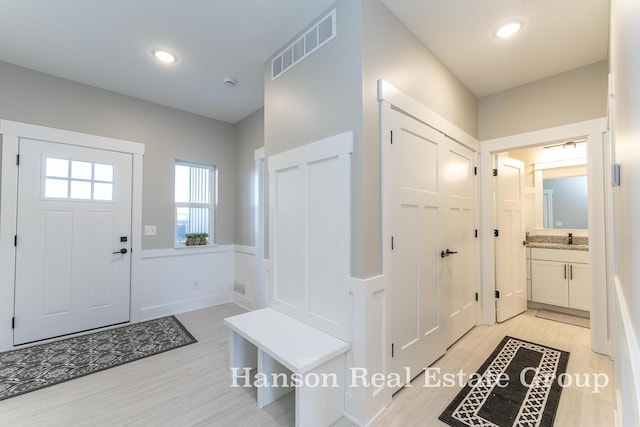 entryway with visible vents, light wood-type flooring, and recessed lighting