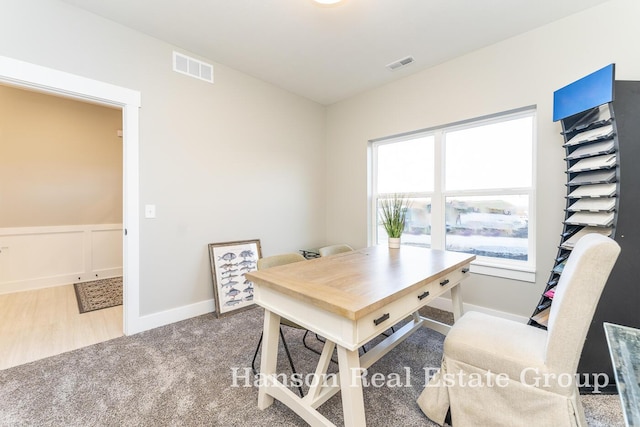 carpeted home office with visible vents and baseboards