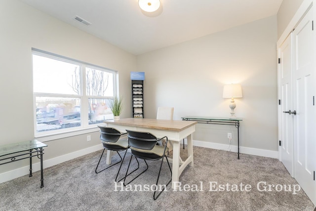 home office featuring visible vents, baseboards, and light carpet