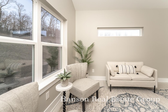 living area featuring baseboards and wood finished floors
