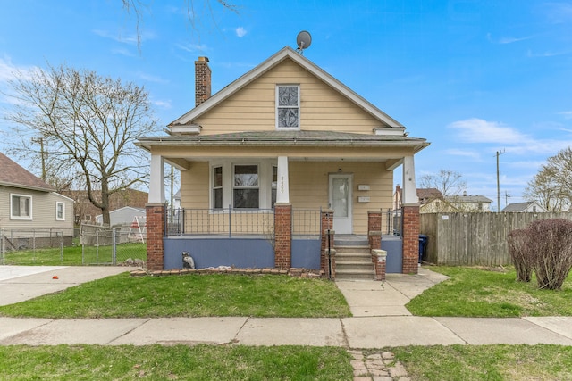 1409 Charter St, Lincoln Park, MI 48146 - view of front of property with a front yard, a porch, fence, and a chimney