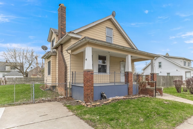 1409 Charter St, Lincoln Park, MI 48146 - view of front of house with a front yard, a porch, fence, and a chimney