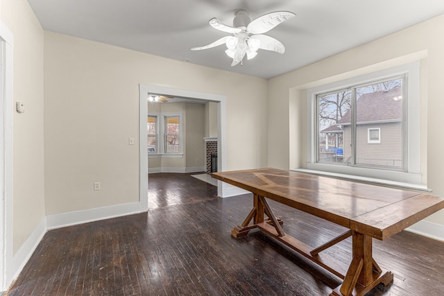 1409 Charter St, Lincoln Park, MI 48146 - dining space with a fireplace, wood-type flooring, baseboards, and a ceiling fan