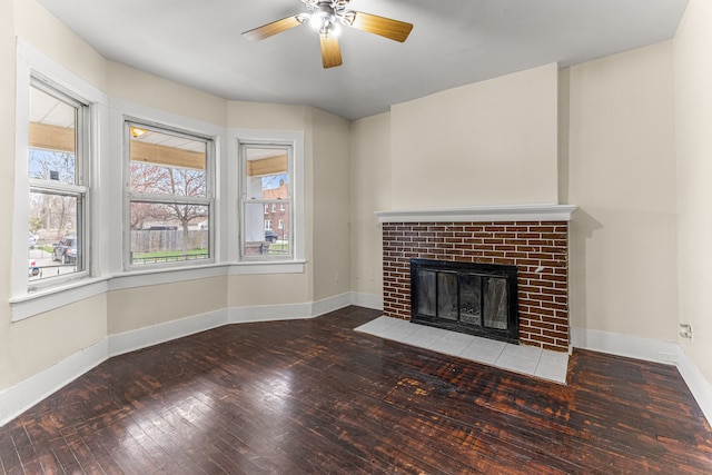 1409 Charter St, Lincoln Park, MI 48146 - unfurnished living room featuring wood-type flooring, ceiling fan, a brick fireplace, and baseboards