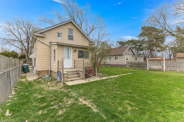 1409 Charter St, Lincoln Park, MI 48146 - rear view of house featuring a yard and a fenced backyard