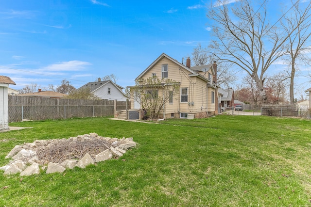 1409 Charter St, Lincoln Park, MI 48146 - back of property featuring a yard, a fenced backyard, a pergola, and a chimney