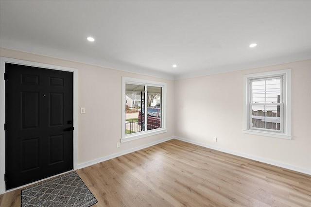 foyer entrance with light wood-type flooring, a healthy amount of sunlight, baseboards, and recessed lighting