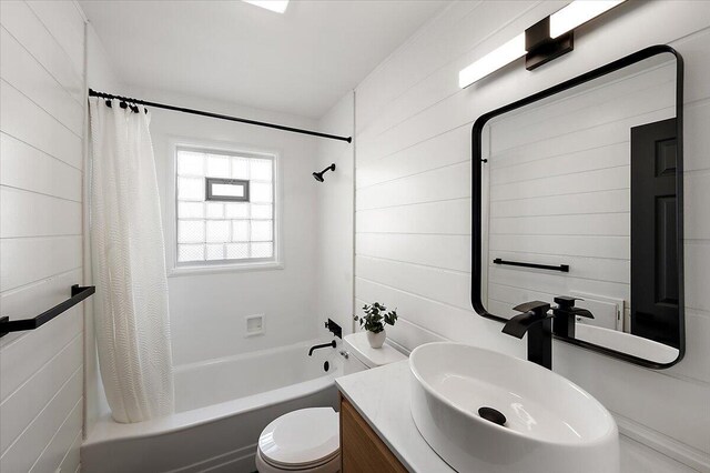 bathroom featuring shower / bath combination with curtain, vanity, and toilet