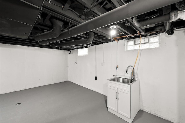 below grade area featuring a sink and a wealth of natural light