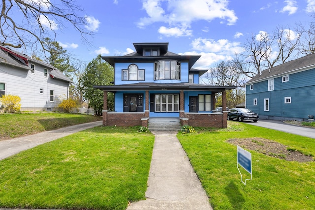 view of front of property featuring a front lawn, brick siding, and a porch