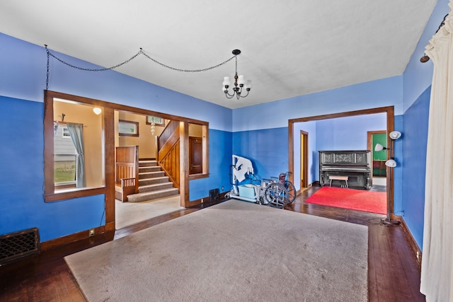 interior space featuring visible vents, baseboards, a glass covered fireplace, and wood-type flooring