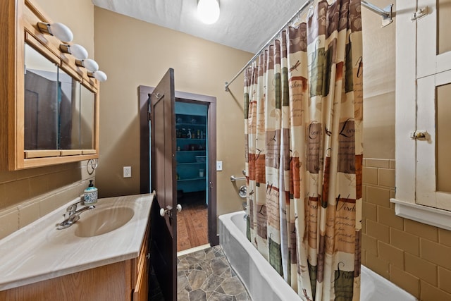 bathroom featuring vanity and shower / bathtub combination with curtain