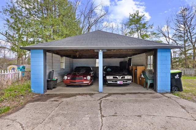 view of parking / parking lot featuring fence