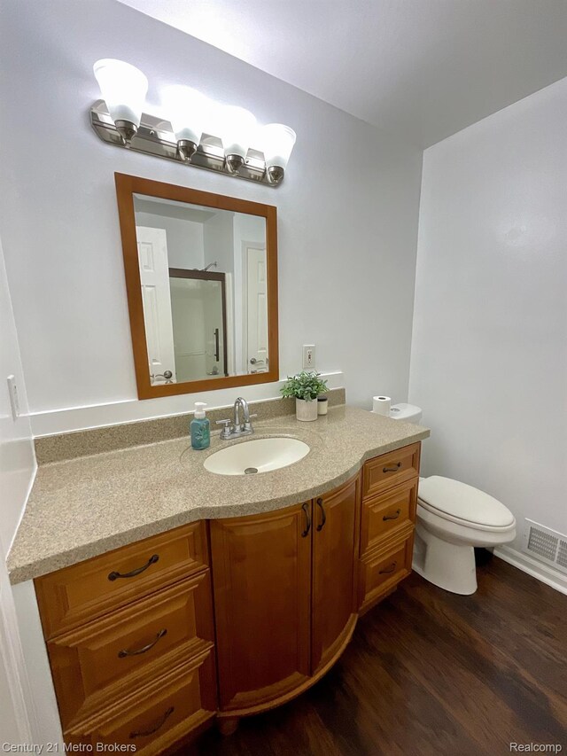 8228 Calkins Rd, Flint, MI 48532 - bathroom with vanity, wood finished floors, and a shower with shower door