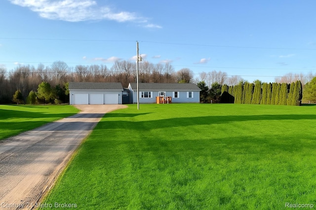8228 Calkins Rd, Flint, MI 48532 - single story home featuring a detached garage and a front lawn