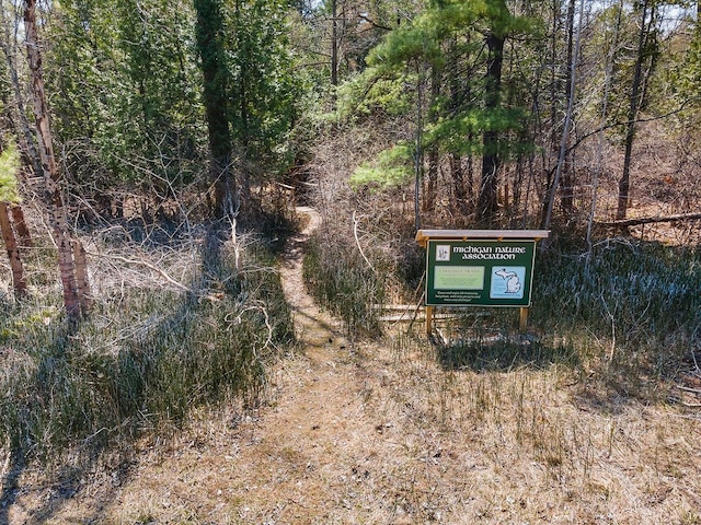 surrounding community featuring a wooded view