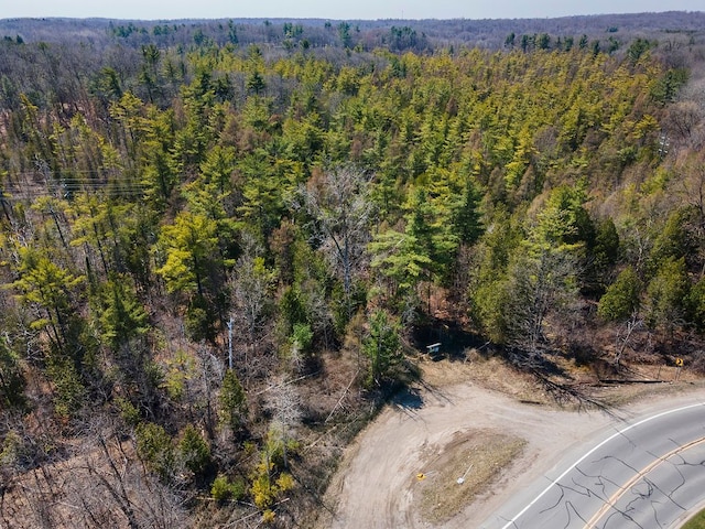 drone / aerial view featuring a view of trees