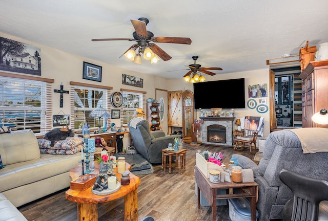 10975 Dorwood Rd, Burt, MI 48417 - living area featuring ceiling fan, wood finished floors, and a fireplace