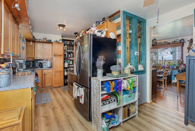 10975 Dorwood Rd, Burt, MI 48417 - kitchen featuring light wood-style flooring, freestanding refrigerator, and ceiling fan