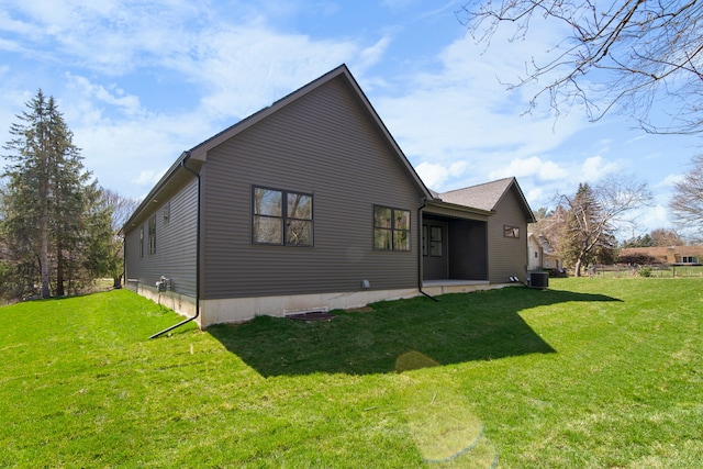 back of house featuring cooling unit and a yard