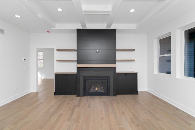 unfurnished living room with recessed lighting, light wood finished floors, visible vents, beam ceiling, and a fireplace