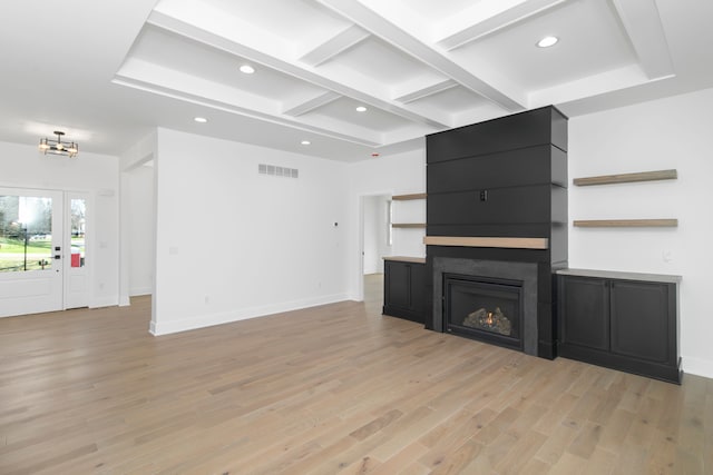 unfurnished living room with recessed lighting, visible vents, light wood-style flooring, and coffered ceiling