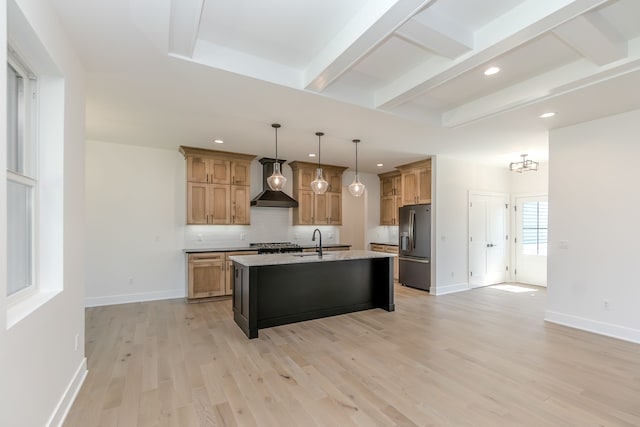 kitchen featuring recessed lighting, wall chimney range hood, a sink, beamed ceiling, and stainless steel fridge