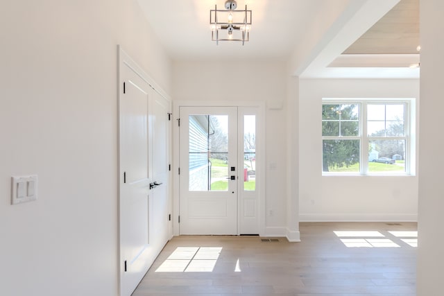 entryway featuring baseboards, light wood-style floors, and visible vents