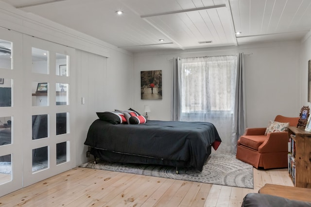 bedroom with wooden ceiling and light wood finished floors
