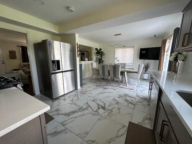 31042 Wellston Dr, Warren, MI 48093 - kitchen featuring hanging light fixtures, marble finish floor, and stainless steel appliances
