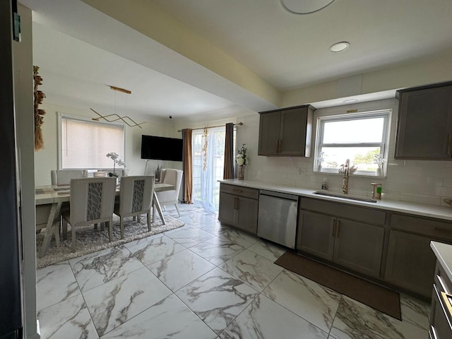 31042 Wellston Dr, Warren, MI 48093 - kitchen featuring marble finish floor, light countertops, dishwasher, a sink, and backsplash