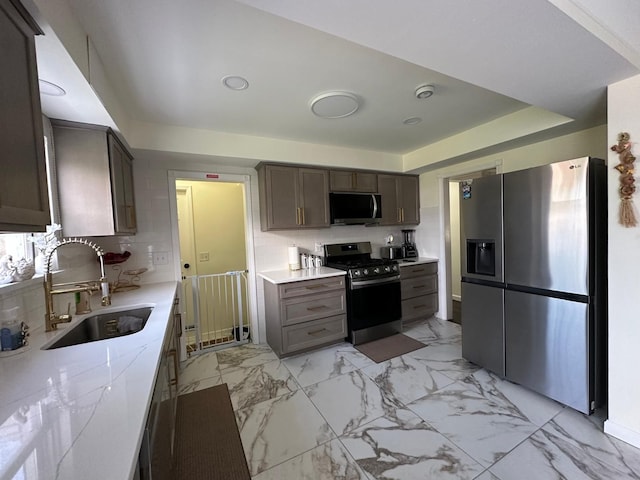 31042 Wellston Dr, Warren, MI 48093 - kitchen with stainless steel appliances, marble finish floor, light countertops, and a sink