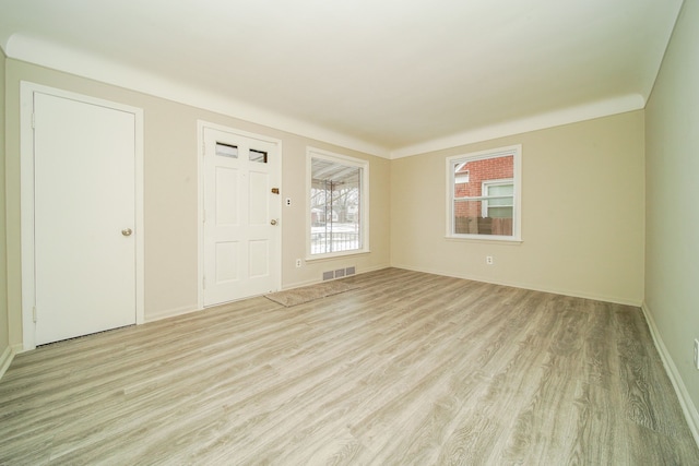 interior space featuring visible vents, baseboards, and light wood-style floors