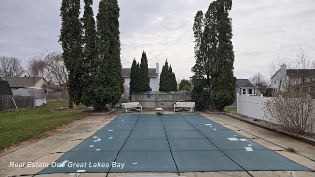 view of pool featuring a patio, a fenced backyard, a fenced in pool, and a lawn