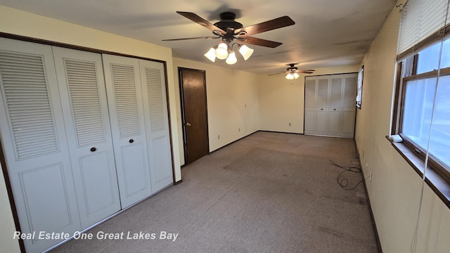 unfurnished bedroom with ceiling fan and carpet flooring