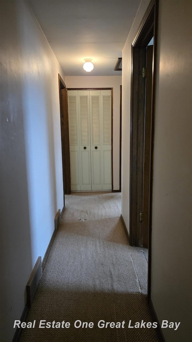 corridor with baseboards, carpet, and visible vents