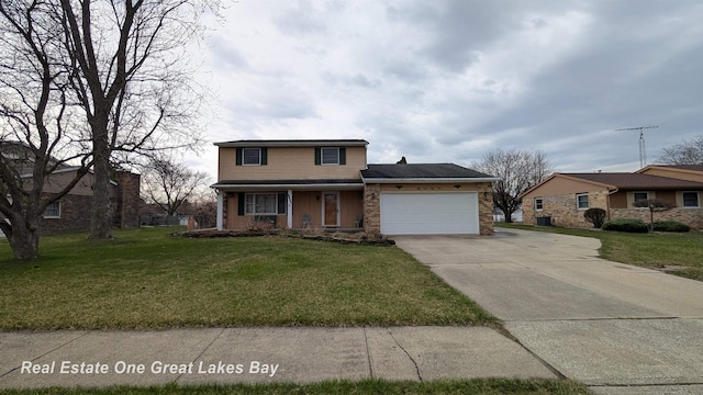 traditional home featuring a front lawn, covered porch, a garage, and concrete driveway