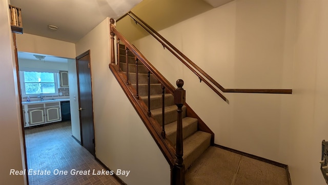 stairway featuring baseboards
