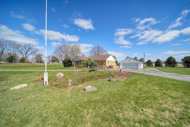 view of front of home with aphalt driveway, an outbuilding, a front lawn, and a detached garage