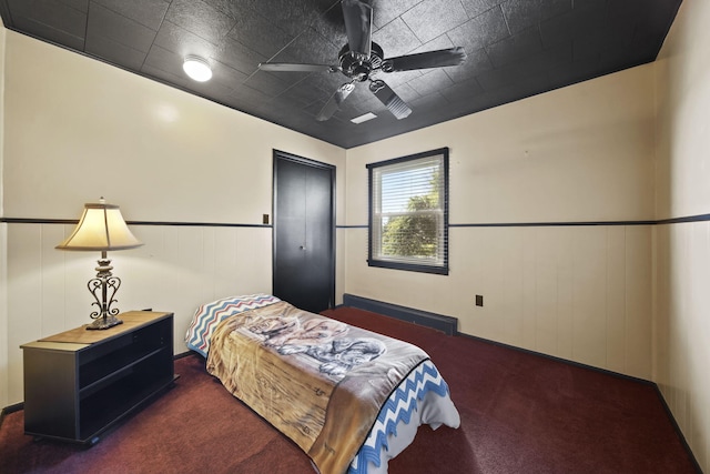 bedroom featuring ceiling fan, carpet, and wainscoting