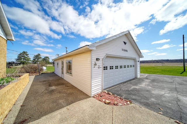 view of property exterior with a garage and an outdoor structure