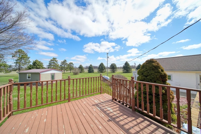 deck with a yard and an outbuilding