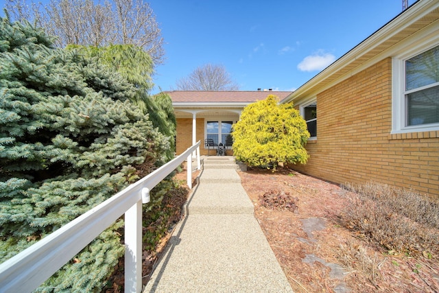 entrance to property featuring brick siding