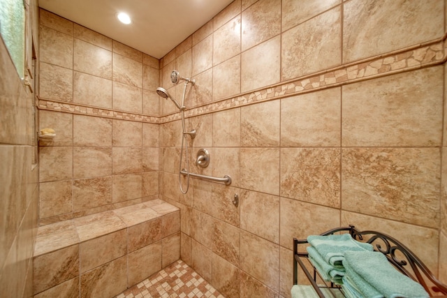 bathroom featuring tiled shower and recessed lighting