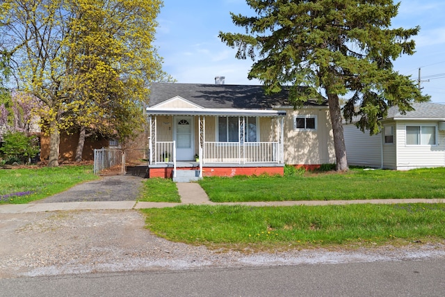 7957 Pine St, Taylor, MI 48180 - bungalow-style house with a porch and a front yard